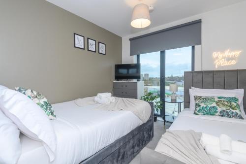 a bedroom with two beds and a balcony at Premium Centre Retreat - Work & Relax - Pool Table in Leeds