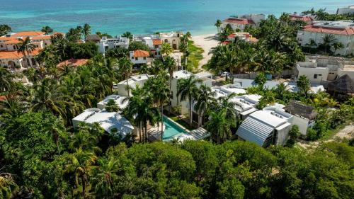 an aerial view of a resort with the ocean at Casa Vela - 2BR - Where Waves Meet Relaxation in Cancún