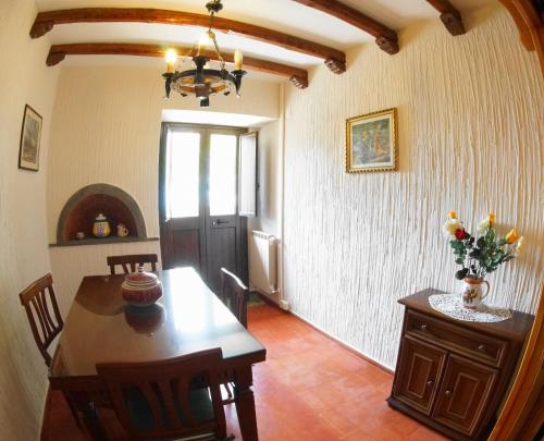 a dining room with a table and a room with a window at Etna Paradise locazioni brevi in Ragalna