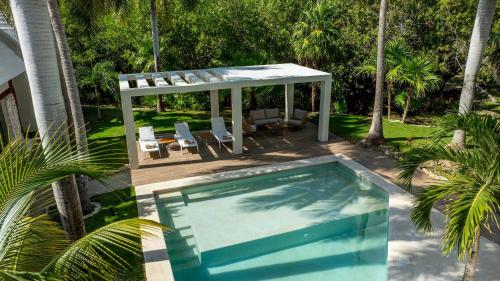 a swimming pool with a gazebo and a swimming poolvisor at Casa Selva - 2BR - Escape Rest Reconnect in Cancún