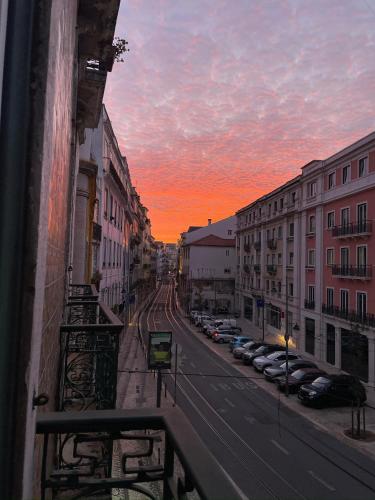 a view of a street at sunset from a balcony at Asul B&B in Lisbon