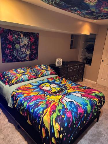 a bedroom with a bed with a colorful blanket at 420 Friendly 12 PM Check Out 1 Bedroom Basement in Chicago