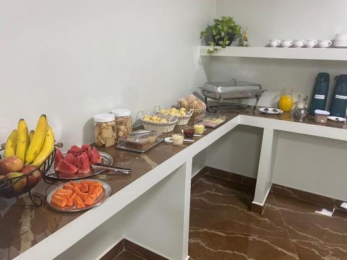 a table with plates of fruits and vegetables on it at Aquarius Hoteis Ltda in Canarana
