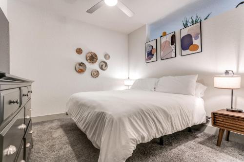 a bedroom with a large white bed and a dresser at Riverwalk Oasis with Riverwalk Views Free Parking in San Antonio