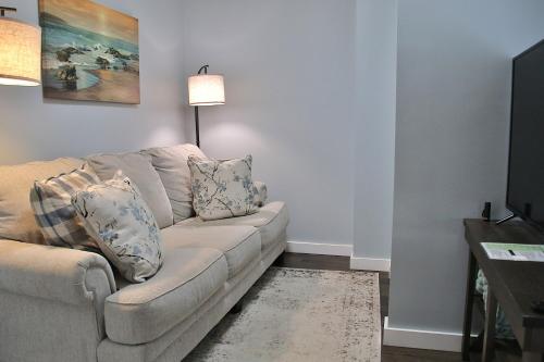 a living room with a couch and a television at The Ultimate Lakewood Retreat! in Lakewood