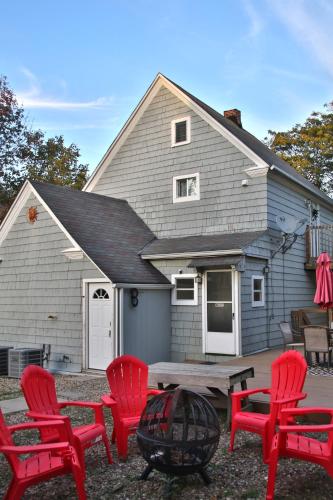 a group of red chairs in front of a house at The Ultimate Lakewood Retreat! in Lakewood