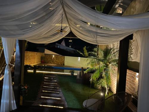 a room with a pool and a white curtain at Casa da Mariah in Arroio do Meio