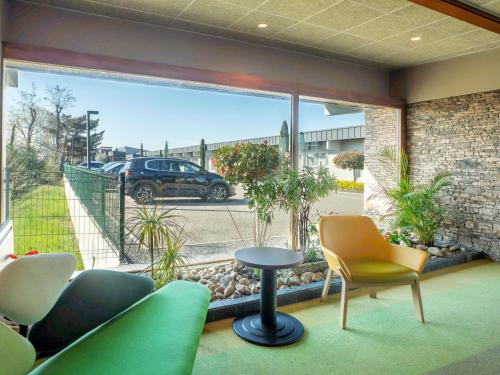 a balcony with a view of a parking lot at Ibis Styles Colmar Nord in Colmar