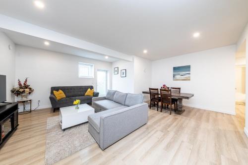 a living room with a couch and a piano at Sunflower Brandnew Cozy Private Suite in Langley