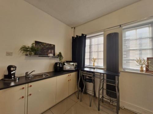 una cocina con fregadero y encimera en Cambridge suites, en Cleethorpes