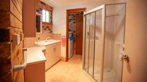 a bathroom with a shower and a sink at Beachview Unit2 ,33 Scenic Drive, Bermagui in Bermagui