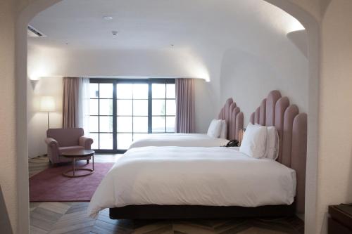 Ένα ή περισσότερα κρεβάτια σε δωμάτιο στο Ecoland Hotel