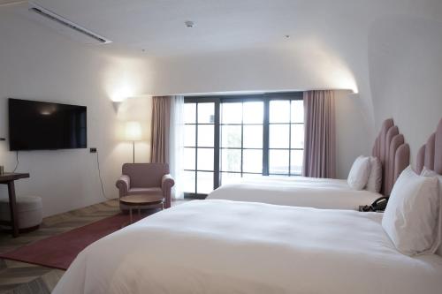 Ένα ή περισσότερα κρεβάτια σε δωμάτιο στο Ecoland Hotel