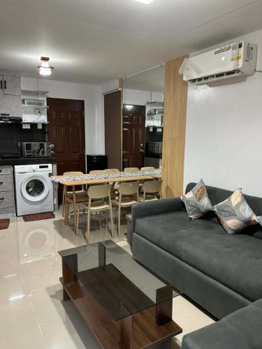 a living room with a couch and a table at Eko's Crib Unit 30 in Sampong