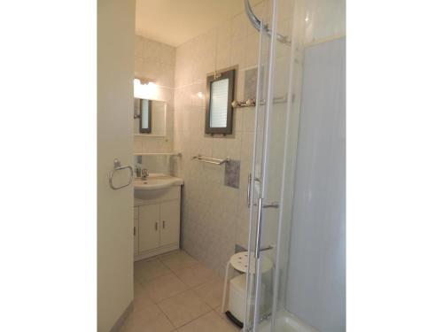 a bathroom with a shower and a toilet and a sink at Holiday Home in Buisson with Private Pool in Buisson