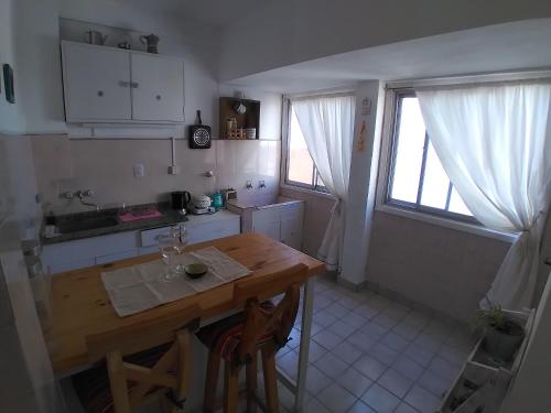a kitchen with a wooden table and a counter top at VISTA AL MAR HOSPEDAJE Solo mujeres in Mar del Plata
