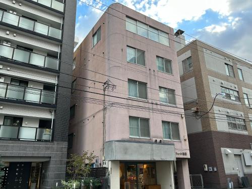 a tall building with many windows on a street at シェール松岡 in Ōdōri