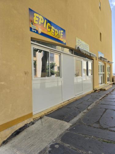 a store with a sign on the side of a building at Love 2 avec Jacuzzi in Cap d'Agde