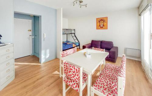 a living room with a white table and chairs at Cozy Apartment In Dunkerque in Dunkerque