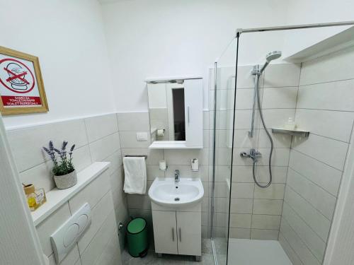 a white bathroom with a shower and a sink at Rooms by the sea Rab - 18786 in Rab
