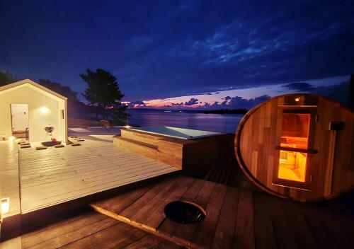 a small wooden deck of a boat at night at Kubikai in Itoshima