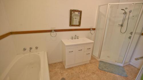伯马吉Blue Bermi Beach House - 10 Barragoot Street的带淋浴、水槽和浴缸的浴室