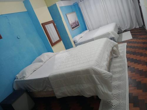 Ένα ή περισσότερα κρεβάτια σε δωμάτιο στο pousada top mix apt303
