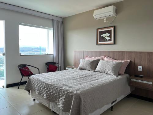 Ένα ή περισσότερα κρεβάτια σε δωμάτιο στο Refúgio Escarpas do Lago Mirante 1702