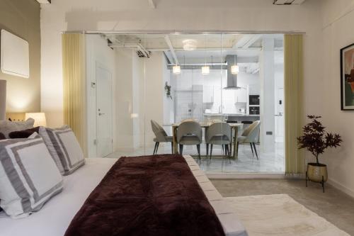 a room with a bed and a dining room at Skyway Luxury Stay with Jacuzzi in Bradford