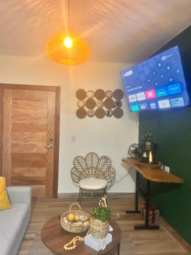 a living room with a couch and a table at El descanso in Higuey