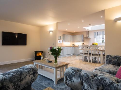 a living room with two couches and a table at Field View - Ukc2304 in Wainfleet All Saints