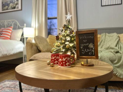 a table with a christmas tree in a living room at The Salt Soul Suite Cozy Apt 5 in Bridgewater