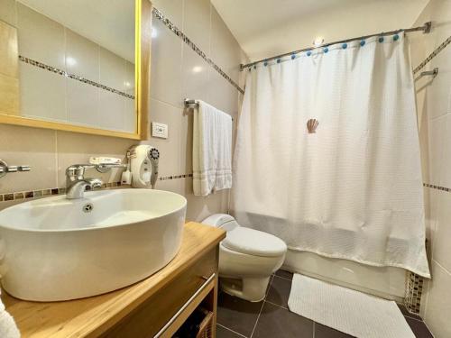 a white bathroom with a sink and a toilet at Apartment in Juan Dolio in Juan Pedro