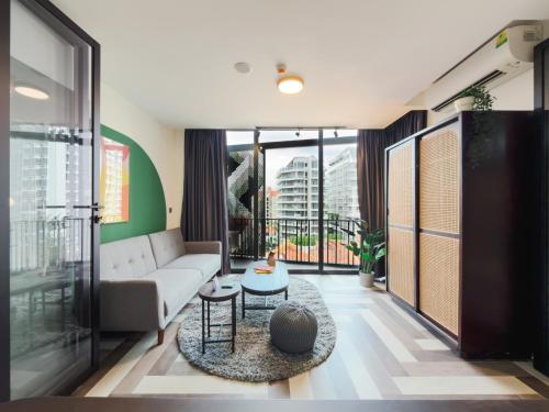 a living room with a couch and a table at Quay 17 by Cove - Brand new serviced apartments - River Valley, Robertson Quay in Singapore