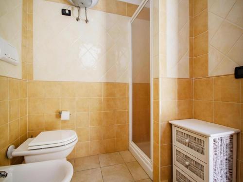 a bathroom with a toilet and a shower at Apartment with garden in Villasimius in Villasimius
