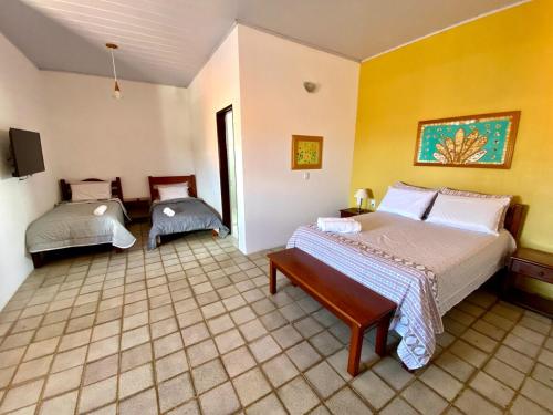 En eller flere senge i et værelse på Casa Adélia - Conforto e aconchego a Beira Mar