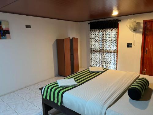 a bedroom with a large bed with a green and white blanket at Ella Berg Haven in Ella