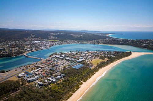 an aerial view of a beach and the ocean at The Black Dolphin Holiday Park in Merimbula
