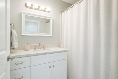 a bathroom with a sink and a shower curtain at Beachside Bliss - Neptune Nook Unit 2 in Jacksonville Beach