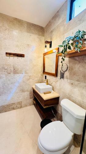 a bathroom with a toilet and a sink at Casa Hamaca Nayarit in Chacala