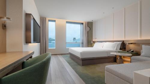 a hotel room with a bed and a couch at Holiday Inn Wenzhou Airport by IHG in Wenzhou