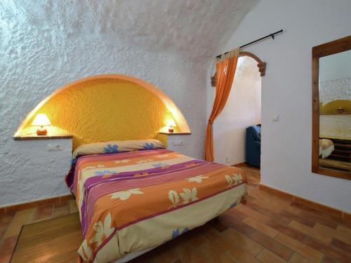 a bedroom with a bed in a room at Cave House in Guadix with Private Pool in Bejarín
