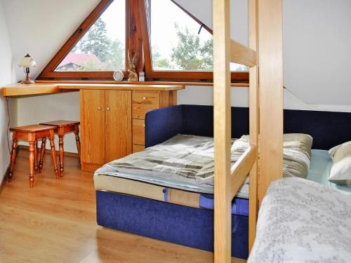 Giường trong phòng chung tại Holiday Home by Lake Rosnowskie with Boat