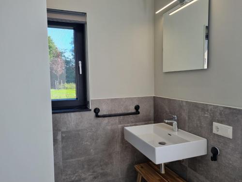 BalkWaterfront Villa w Jetty的一间带白色水槽和窗户的浴室