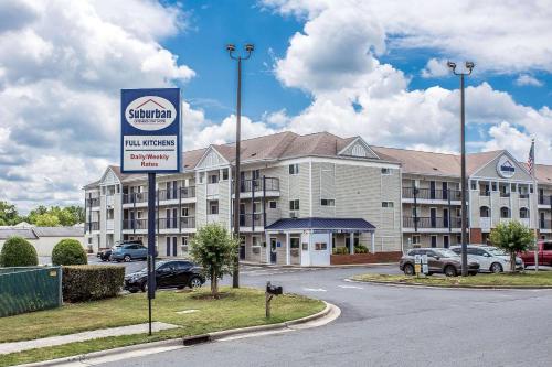a large building with a sign in front of it at Suburban Studios Charlotte - Ballantyne in Charlotte