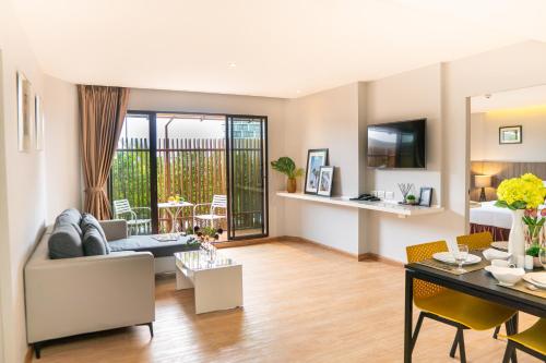 a living room with a couch and a table at Jazzotel Bangkok in Bangkok