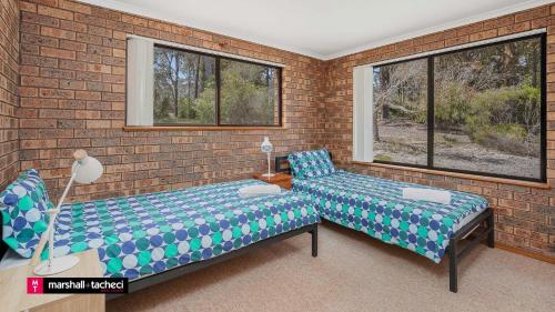 Giường trong phòng chung tại Cuttagee Beach Cottage 1