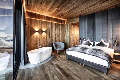 a bedroom with a bed and a bath tub at Apartment in Kaltenbach with Ski-In Ski-Out in Mühlfeld