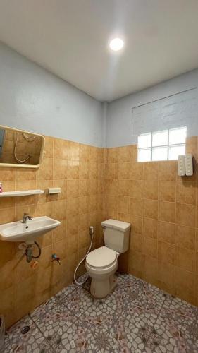 a bathroom with a toilet and a sink at Gypsy Village Resort in Phi Phi Islands