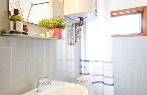 a bathroom with a sink and a toilet and a window at 10000-1-Rorvig-Birkealle-2-A in Rørvig